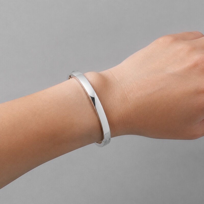 Silver stainless steel bangle worn on wrist