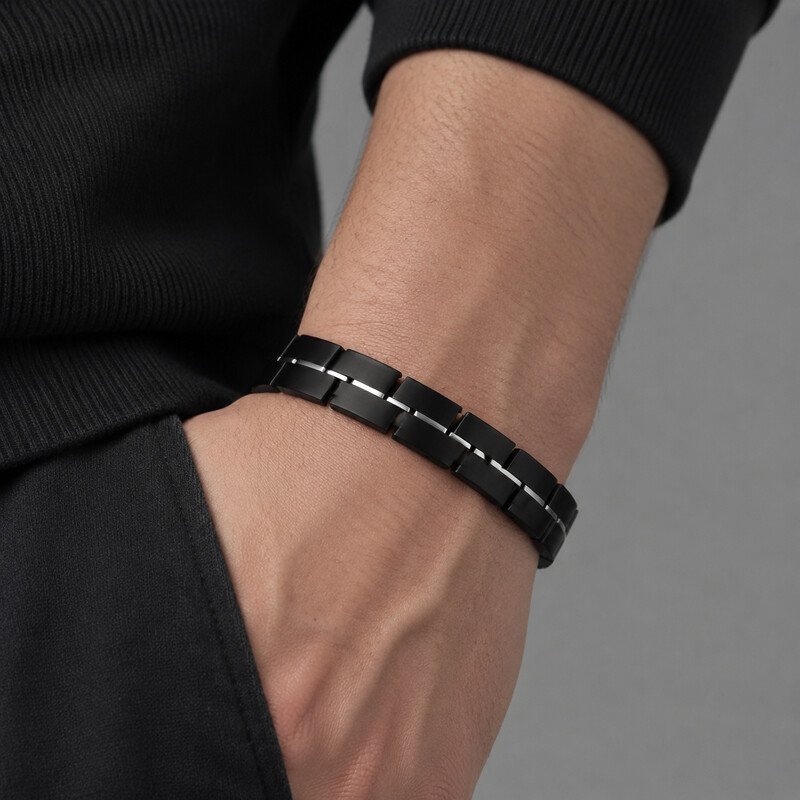Mens black stainless steel bracelet worn on wrist