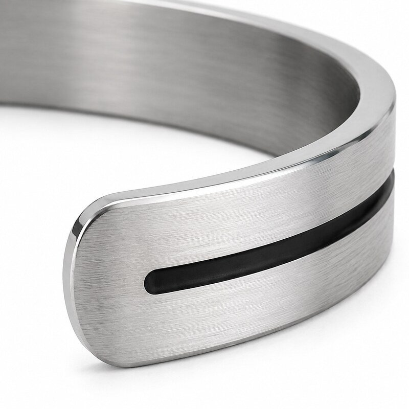 Close-up of brushed stainless steel cuff polished edges and black enamel groove