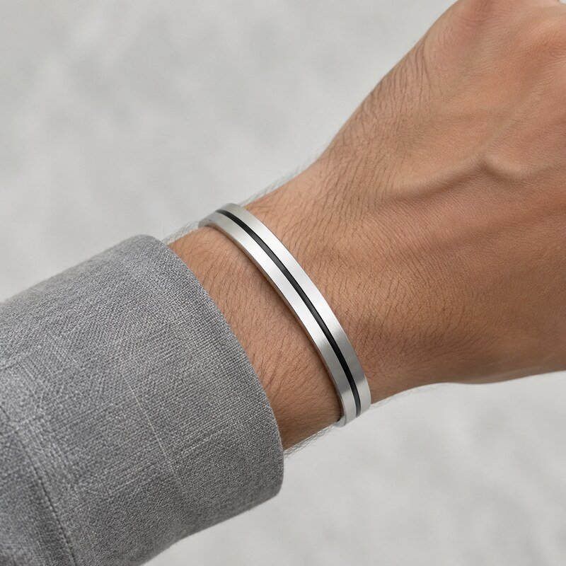 Modern brushed stainless steel cuff bracelet worn naturally on the wrist