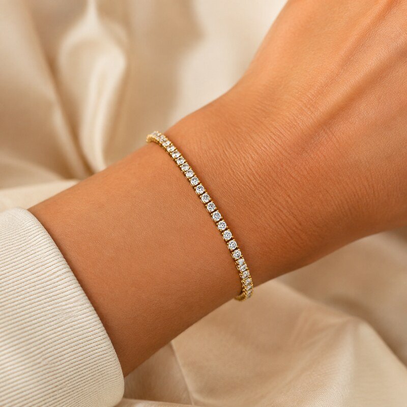 Women's gold stainless steel tennis bracelet with clear CZ stones worn on the wrist