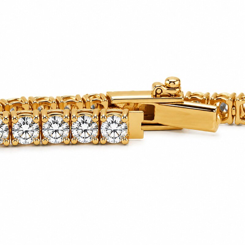 Close-up of clear CZ prong settings and hidden box clasp on a gold tennis bracelet