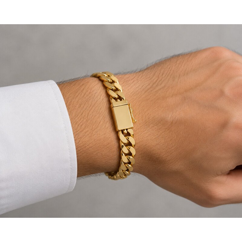 Men's gold curb chain bracelet worn on wrist