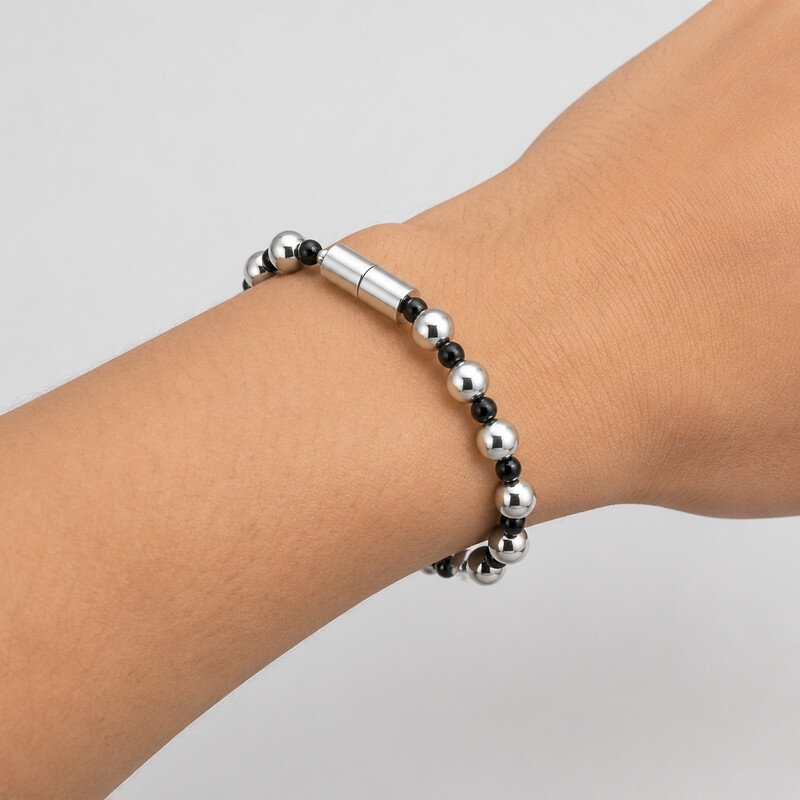 Silver and black beaded bracelet worn on wrist