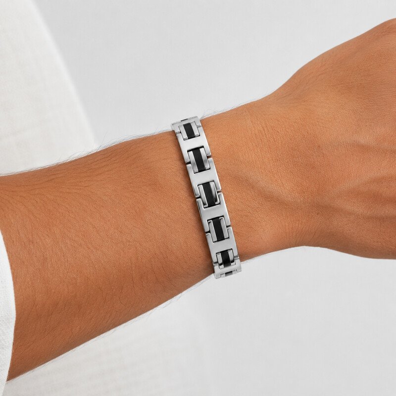 Silver and black stretch bracelet worn on wrist