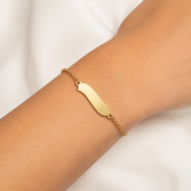 Gold personalized name bracelet worn on wrist
