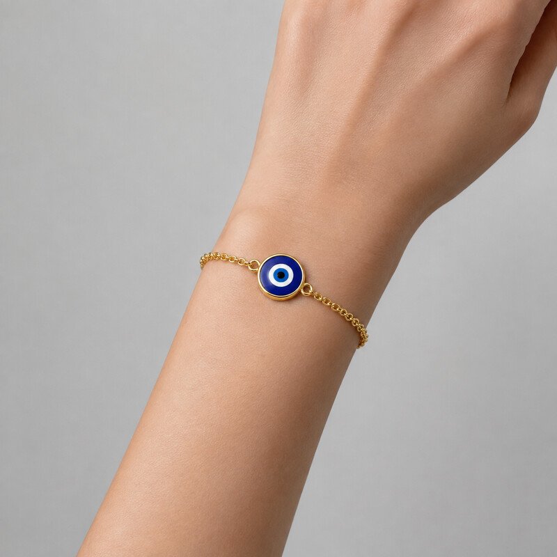 Gold evil eye bracelet worn on wrist