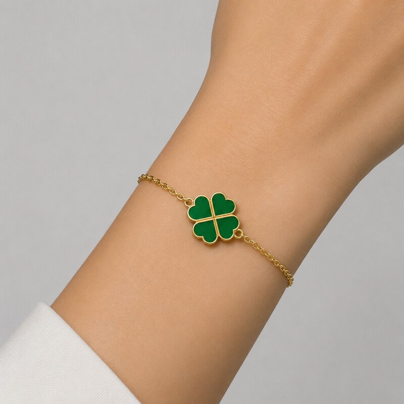 Gold clover bracelet worn on wrist
