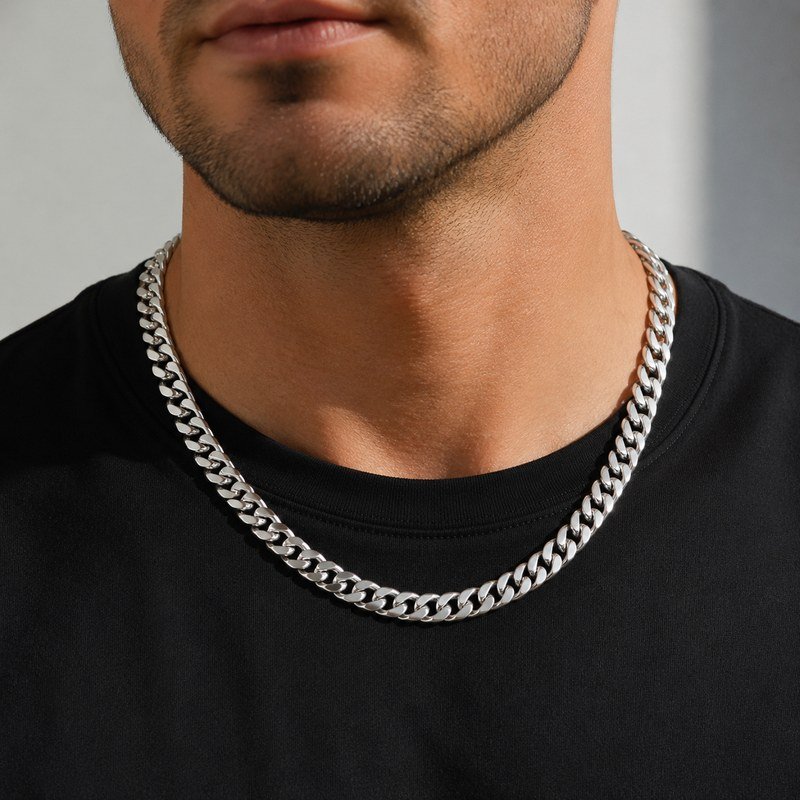 Male model wearing a polished silver stainless steel Cuban link necklace