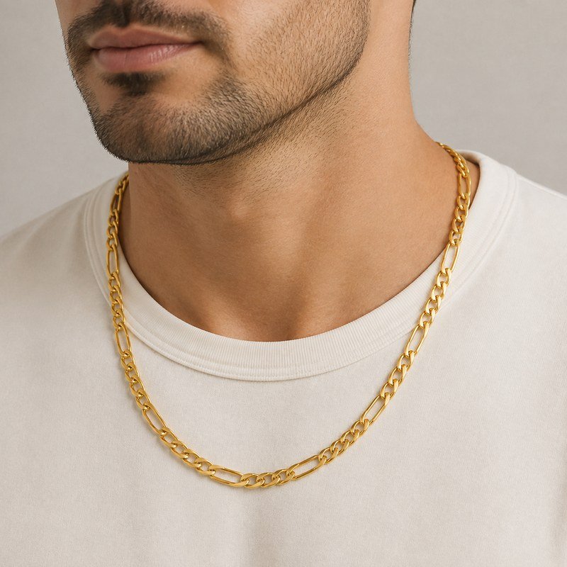 Male model wearing a polished gold stainless steel Figaro chain necklace