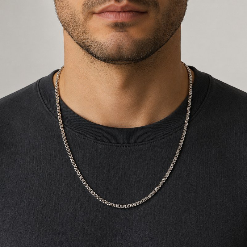 Male model wearing a polished silver stainless steel box chain necklace