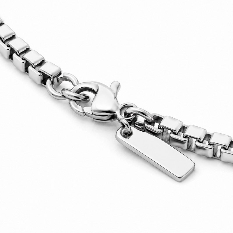 Close-up of the lobster clasp and end tag on a stainless steel box chain