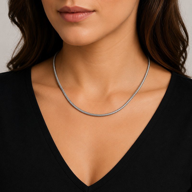 Woman wearing a silver stainless steel snake chain necklace, 4 mm wide and adjustable length