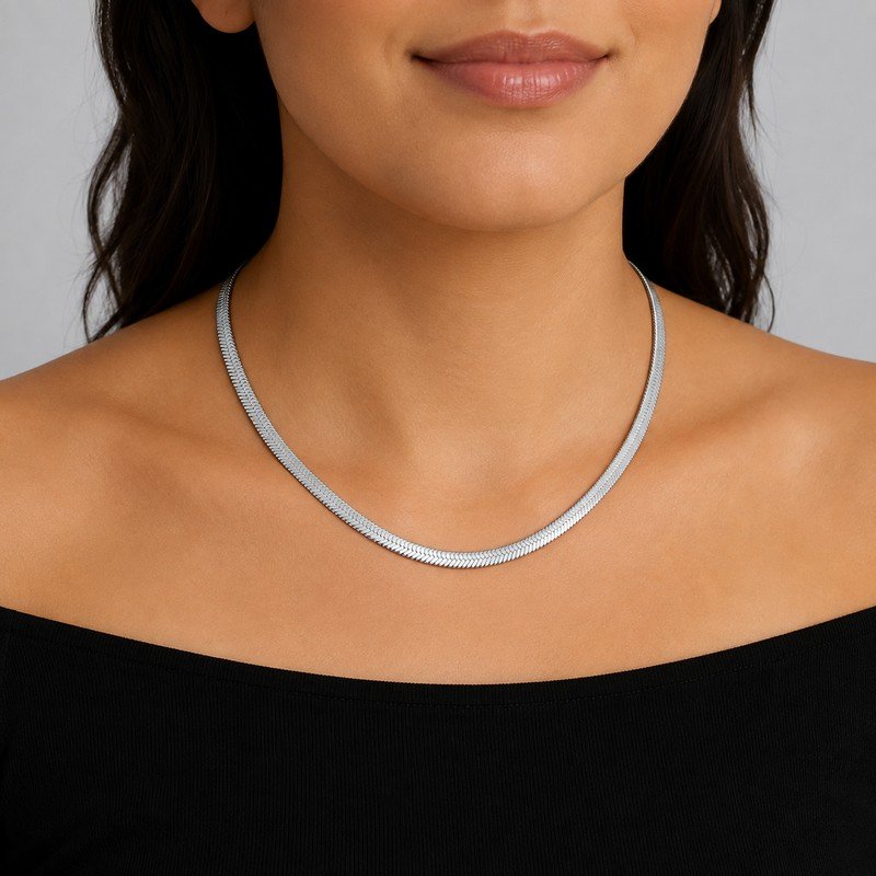 Woman wearing a silver stainless steel herringbone chain necklace
