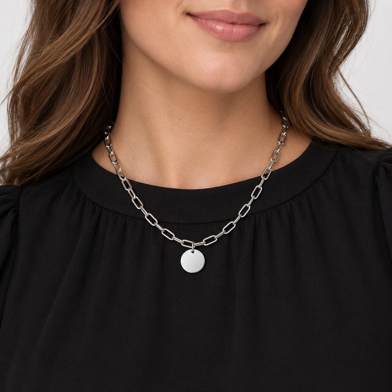 Adult woman wearing a silver Stainless Steel paperclip chain with round disc pendant