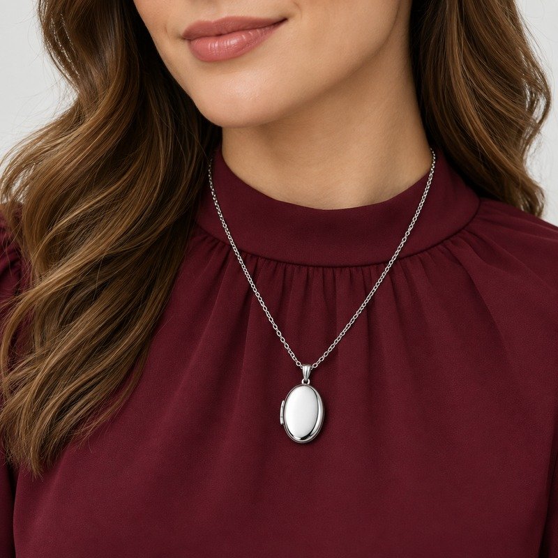 Adult woman wearing a silver Stainless Steel oval locket necklace
