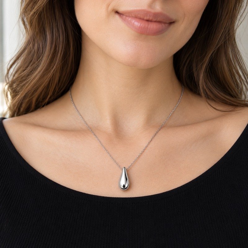 Woman wearing a silver Stainless Steel teardrop pendant necklace