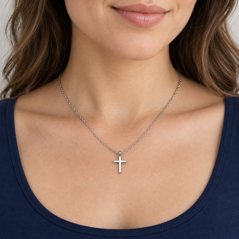 womens silver Stainless Steel petite cross pendant necklace, worn by an adult model