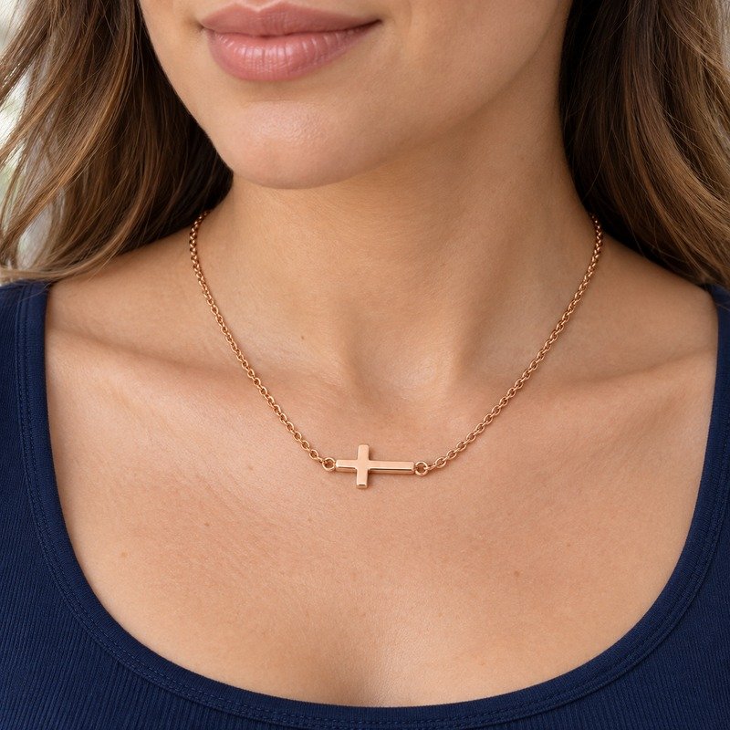 womens rose gold Stainless Steel sideways cross pendant necklace, worn by an adult model