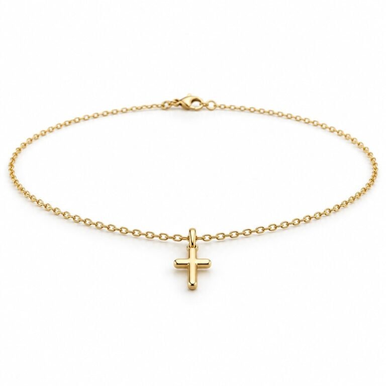 womens gold Stainless Steel petite cross pendant necklace, at a 45-degree angle on white