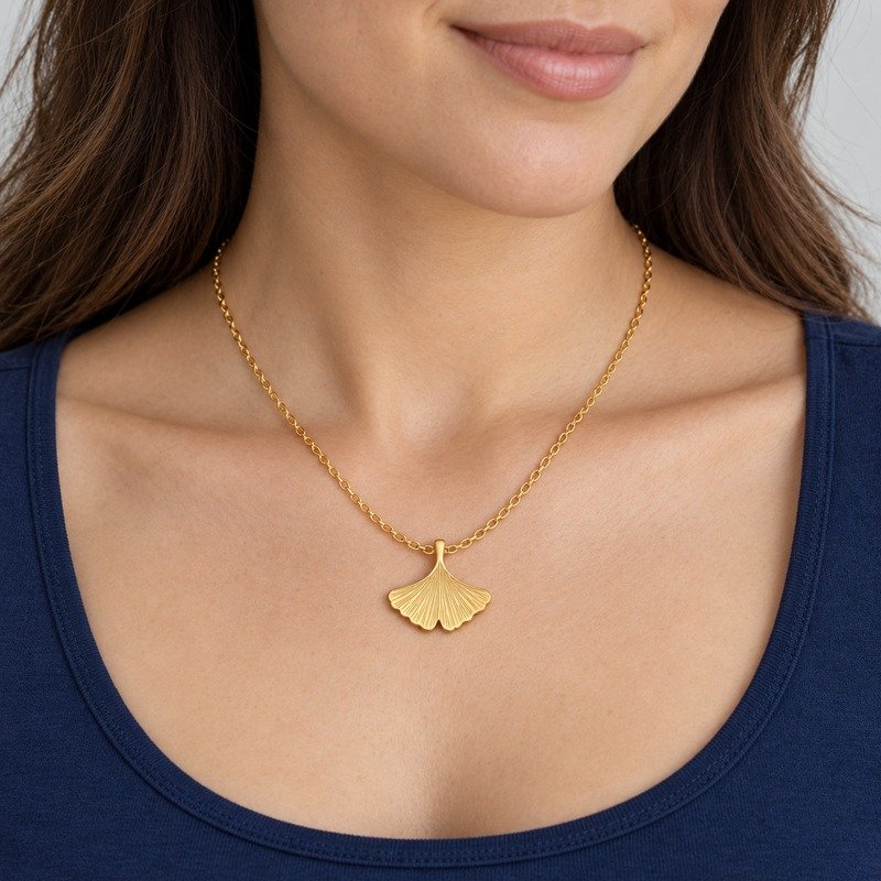 womens gold Stainless Steel ginkgo leaf pendant necklace, worn by an adult model