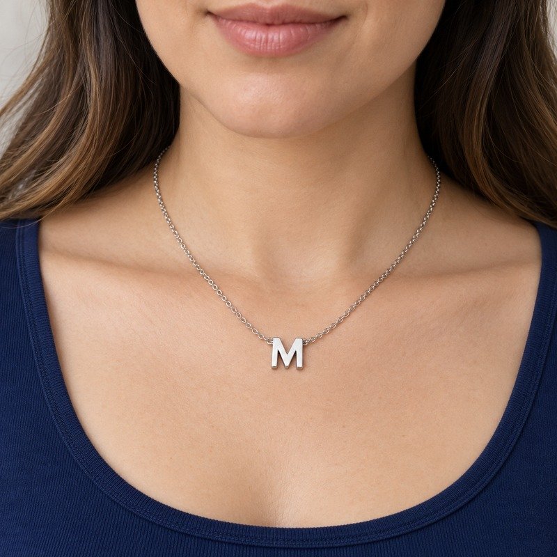 womens silver Stainless Steel initial m necklace, worn by an adult model