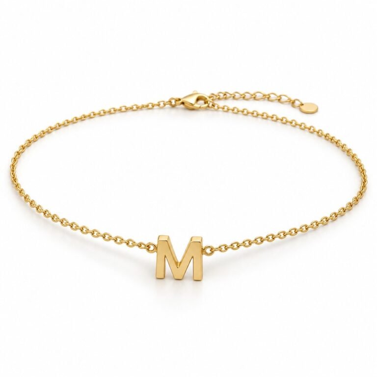 womens gold Stainless Steel initial m necklace, at a 45-degree angle on white