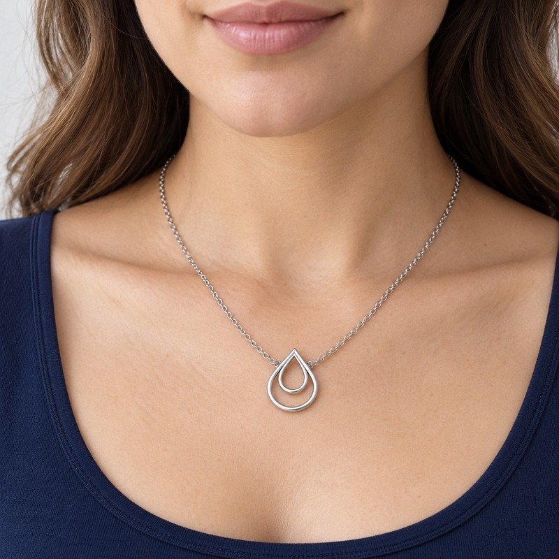 womens silver Stainless Steel double teardrop necklace, worn by an adult model