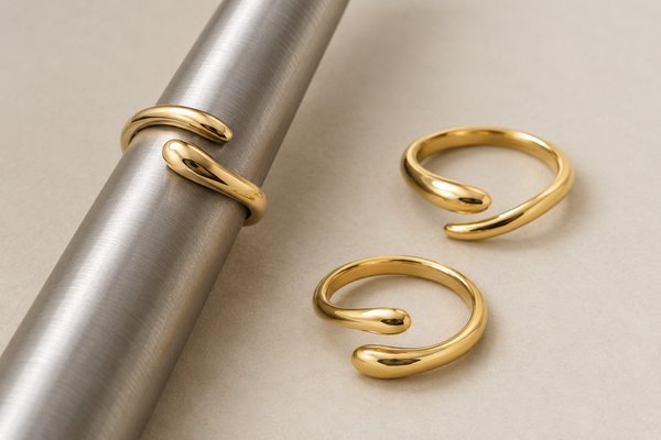 gold stainless steel minimalist open wrap rings: a ring on a plain sizing mandrel without visible markings