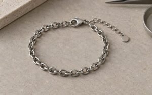 AI-generated editorial illustration: steel bracelet with lobster clasp and short extension chain arranged flat