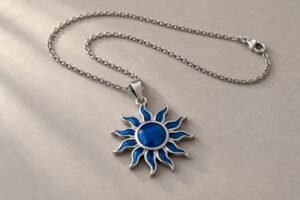Stainless steel sun-shaped pendant with blue enamel