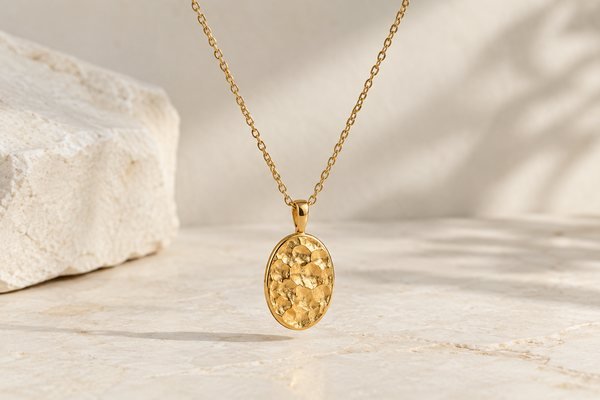 Illustrative Oval pendant suspended from a fine chain