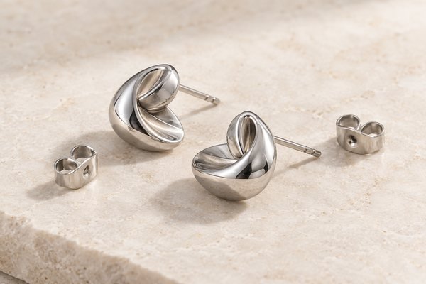 Illustrative Stud earring pair with separate butterfly backs